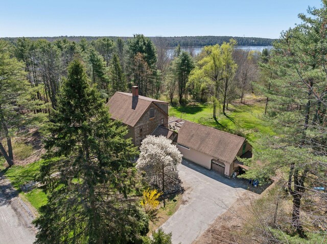 birds eye view of property with a wooded view