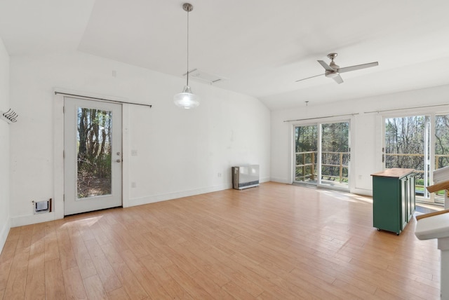 unfurnished living room featuring a ceiling fan, baseboards, lofted ceiling, and light wood finished floors