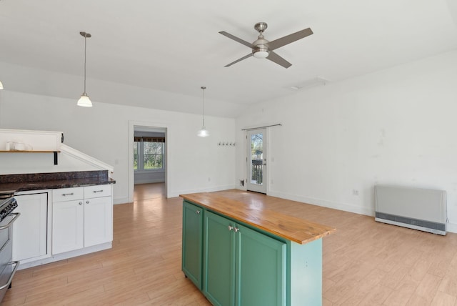 kitchen featuring wood counters, light wood finished floors, ceiling fan, and green cabinetry