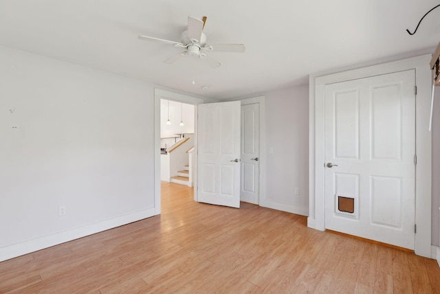 unfurnished bedroom with baseboards, ceiling fan, and light wood finished floors