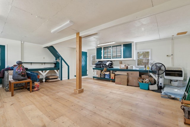 interior space with heating unit and hardwood / wood-style flooring