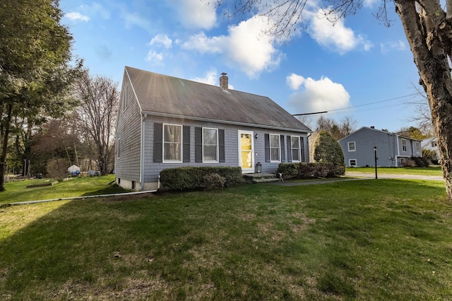 view of front of house featuring a front yard and a chimney