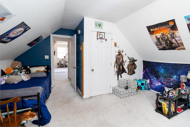 carpeted bedroom with lofted ceiling