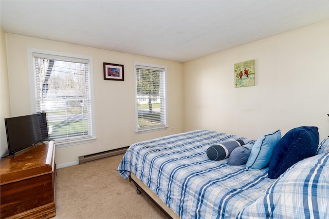 carpeted bedroom featuring baseboards and baseboard heating