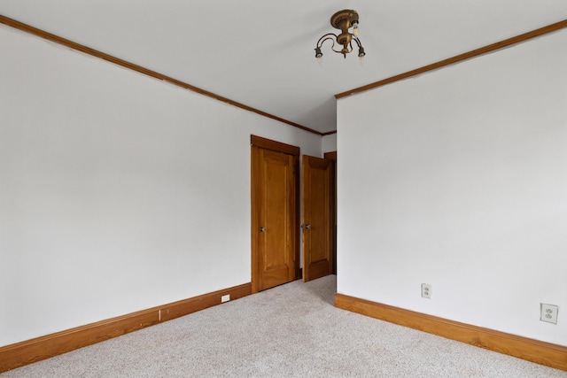 175 Summer St, Auburn, ME 04210 - spare room featuring carpet floors, crown molding, and a chandelier
