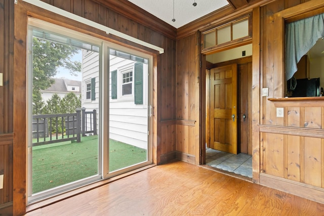 175 Summer St, Auburn, ME 04210 - entryway featuring wooden walls, wood finished floors, and ornamental molding