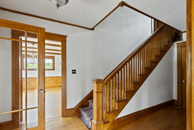 175 Summer St, Auburn, ME 04210 - stairway featuring crown molding, wood finished floors, and a textured ceiling