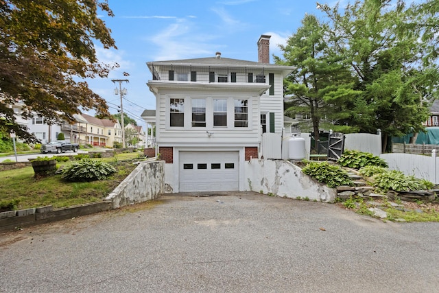 175 Summer St, Auburn, ME 04210 - view of front facade featuring a chimney, an attached garage, and driveway
