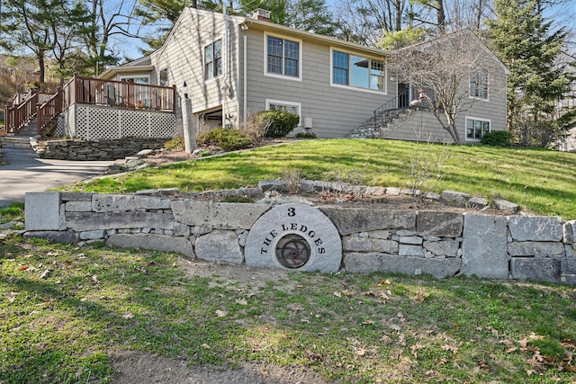 3 The Ledges St, Hallowell, ME 04347 - view of side of home with a lawn, a wooden deck, a chimney, and stairway