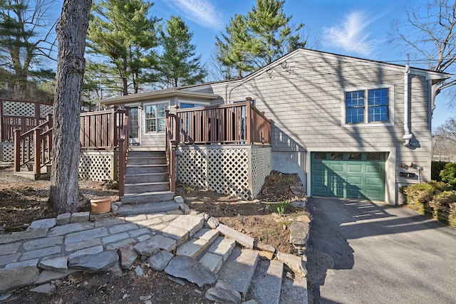 3 The Ledges St, Hallowell, ME 04347 - view of front of home featuring stairs, a garage, aphalt driveway, and a wooden deck