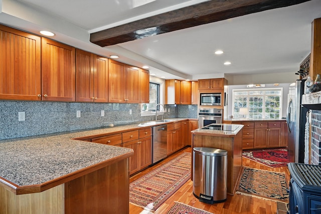 3 The Ledges St, Hallowell, ME 04347 - kitchen featuring a peninsula, light wood finished floors, appliances with stainless steel finishes, and brown cabinets