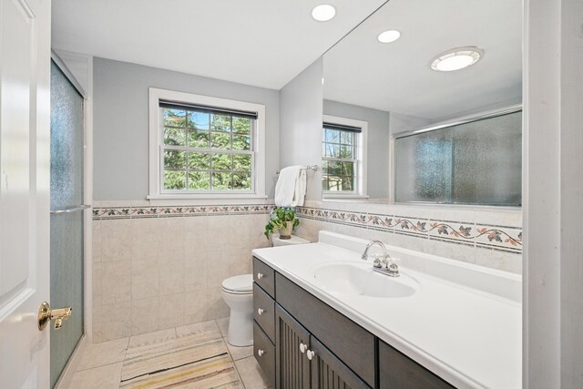 3 The Ledges St, Hallowell, ME 04347 - bathroom featuring tile patterned flooring, vanity, toilet, tile walls, and a shower stall