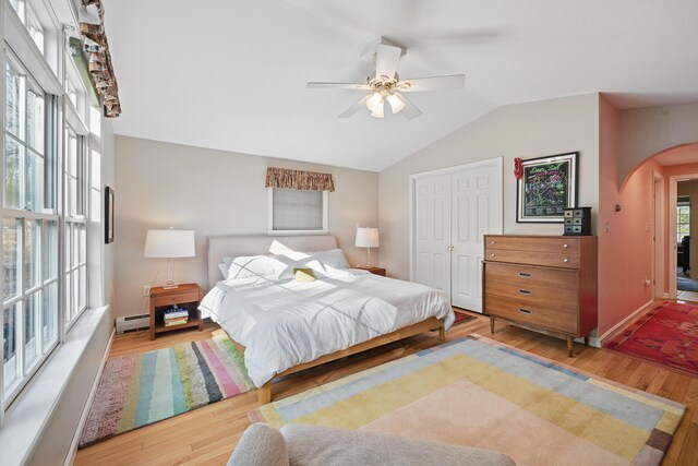 3 The Ledges St, Hallowell, ME 04347 - bedroom featuring wood finished floors, ceiling fan, baseboard heating, arched walkways, and vaulted ceiling