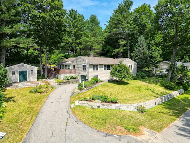 3 The Ledges St, Hallowell, ME 04347 - view of front of property featuring an outdoor structure, a front lawn, asphalt driveway, a chimney, and a deck