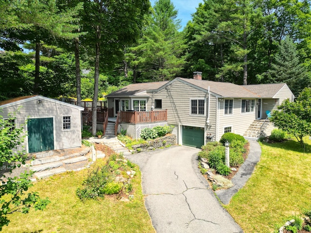 3 The Ledges St, Hallowell, ME 04347 - view of front of house featuring stairway, an attached garage, asphalt driveway, an outdoor structure, and a chimney