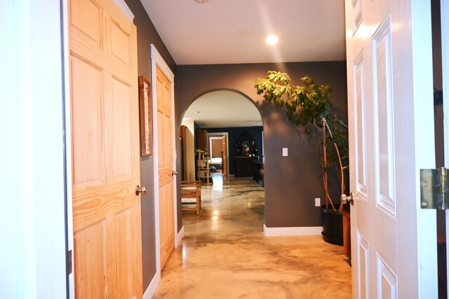 18 Castle Rd, Harmony, ME 04942 - corridor featuring recessed lighting, arched walkways, baseboards, and concrete floors