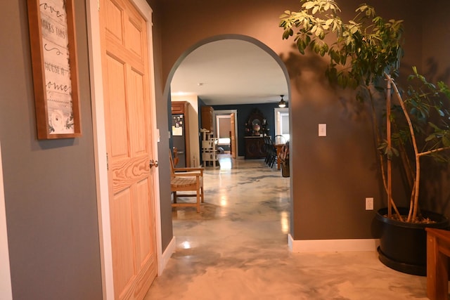 18 Castle Rd, Harmony, ME 04942 - corridor featuring arched walkways, baseboards, and concrete floors
