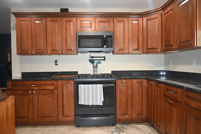 18 Castle Rd, Harmony, ME 04942 - kitchen featuring dark stone counters, stainless steel microwave, and gas stove