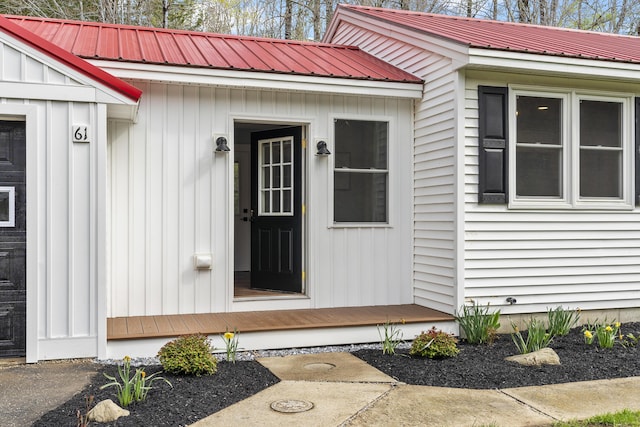 doorway to property with metal roof and board and batten siding
