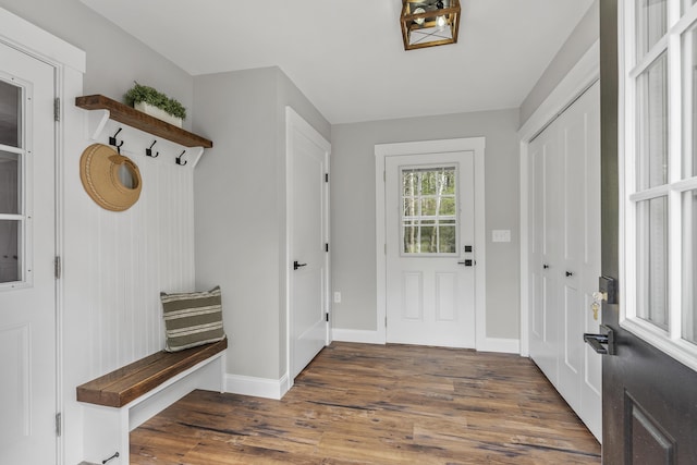 mudroom with wood finished floors and baseboards