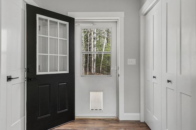 entryway with wood finished floors and baseboards