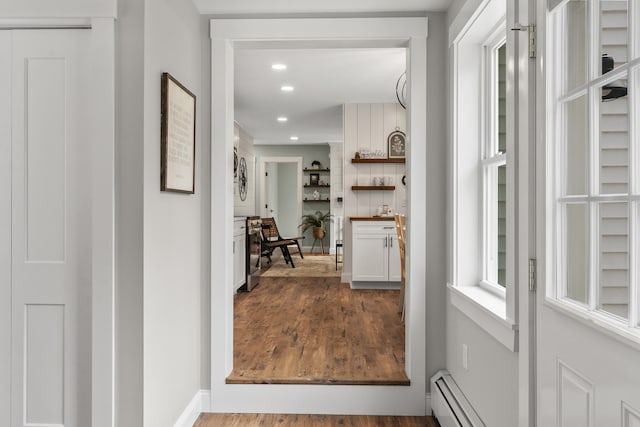 corridor featuring recessed lighting, dark wood finished floors, baseboards, and baseboard heating