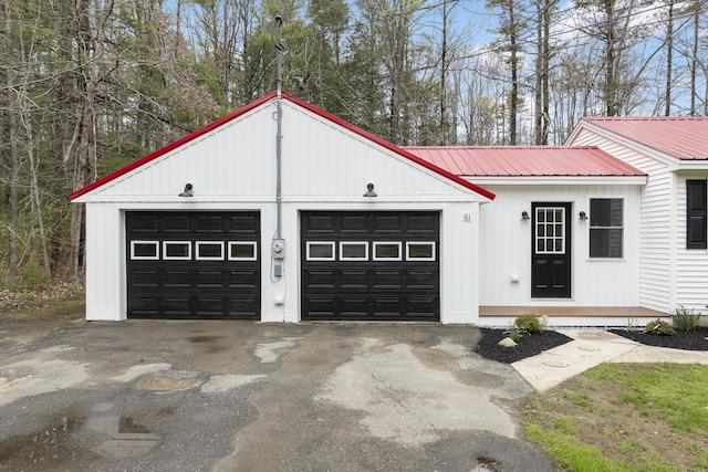 garage with asphalt driveway