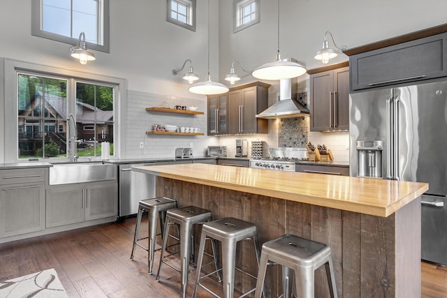28 Fisher Rd, Newry, ME 04261 - kitchen with appliances with stainless steel finishes, a sink, wood counters, wall chimney range hood, and a high ceiling