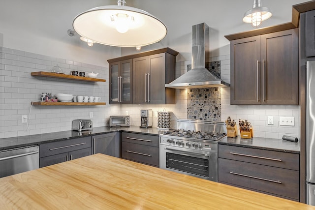 28 Fisher Rd, Newry, ME 04261 - kitchen with wall chimney range hood, stainless steel appliances, backsplash, and dark brown cabinets