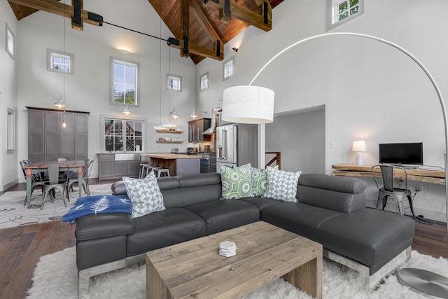 28 Fisher Rd, Newry, ME 04261 - living area featuring high vaulted ceiling, wood finished floors, wooden ceiling with exposed beams, and an office area