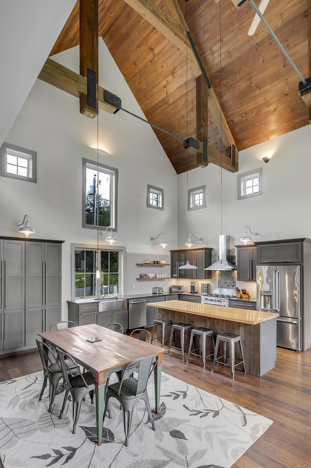 28 Fisher Rd, Newry, ME 04261 - dining room with high vaulted ceiling, dark wood-style flooring, and wood ceiling with exposed beams
