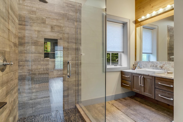 28 Fisher Rd, Newry, ME 04261 - bathroom with a shower stall, vanity, wood finished floors, and baseboards