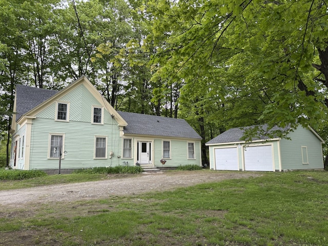 111 Town Farm Rd, Farmington, ME 04938 - view of front of property featuring an outbuilding, roof with shingles, a detached garage, a front lawn, and entry steps