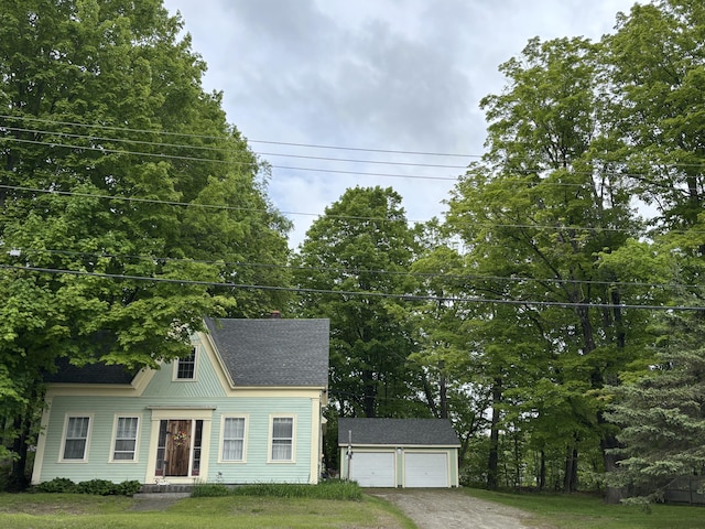 111 Town Farm Rd, Farmington, ME 04938 - view of front of house featuring an outbuilding, driveway, a shingled roof, and a front yard