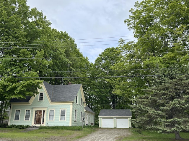 111 Town Farm Rd, Farmington, ME 04938 - view of front facade featuring an outdoor structure, a detached garage, roof with shingles, and a front lawn