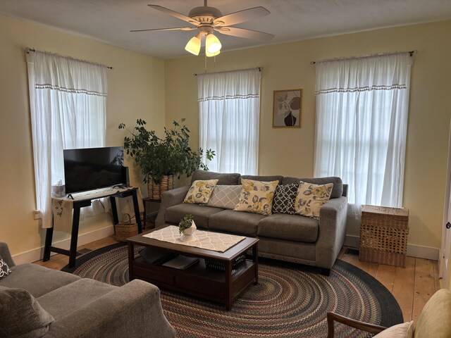 111 Town Farm Rd, Farmington, ME 04938 - living room featuring plenty of natural light, ceiling fan, hardwood / wood-style flooring, and baseboards