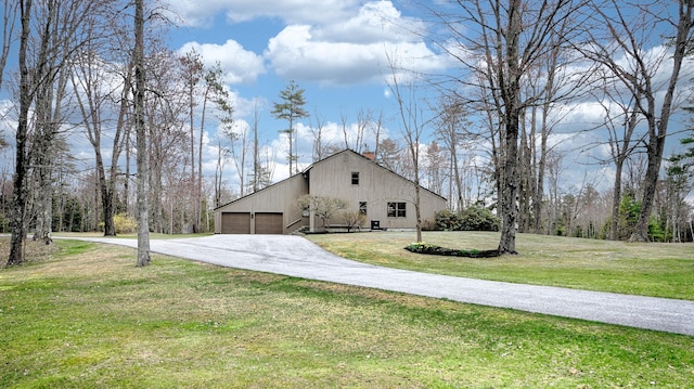 view of property exterior featuring concrete driveway, a yard, a chimney, and a garage