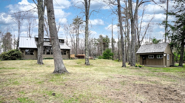 view of yard with an outdoor structure and a shed