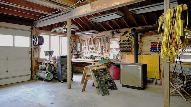 garage with water heater, fridge, and a workshop area