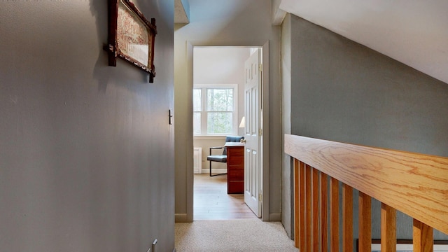 hall featuring light carpet