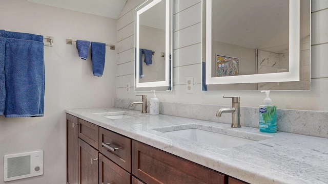 full bath with double vanity, visible vents, and a sink
