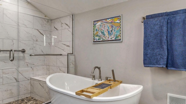 full bathroom with visible vents, lofted ceiling, a freestanding bath, and a shower stall