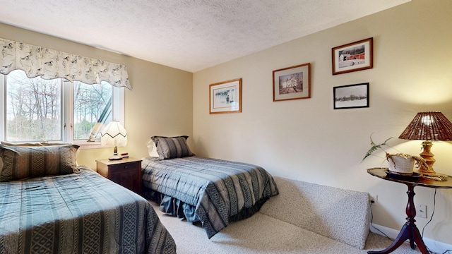 bedroom featuring a textured ceiling and carpet