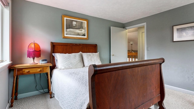 carpeted bedroom featuring baseboards