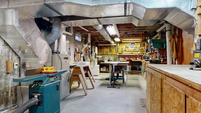 unfinished basement with a workshop area