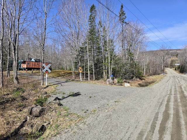 view of road featuring a wooded view