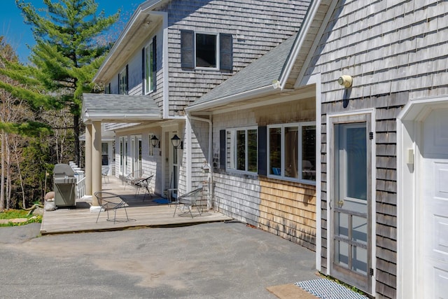 20 Giant Slide Rd, Mount Desert, ME 04660 - property entrance with a wooden deck, a shingled roof, and a patio area