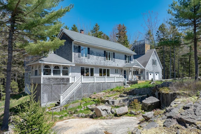 20 Giant Slide Rd, Mount Desert, ME 04660 - view of front of home featuring a wooden deck, a chimney, stairway, a garage, and a sunroom