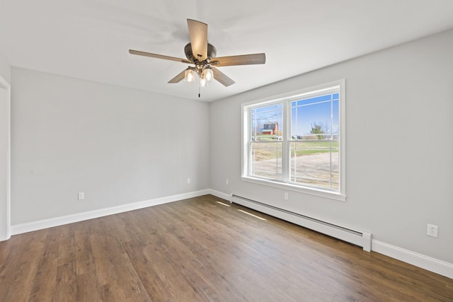 unfurnished room with baseboards, a ceiling fan, a baseboard heating unit, and dark wood-style floors