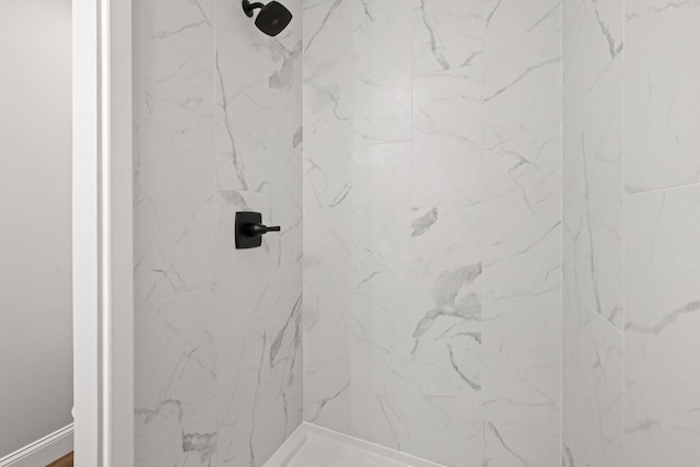 bathroom with a marble finish shower